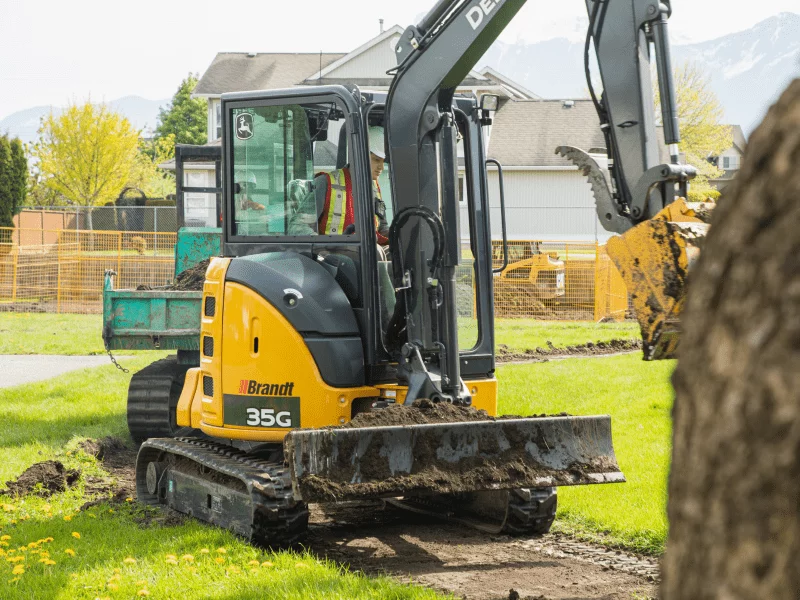 John Deere mini excavator landscaping a yard digging